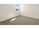 Light-filled bedroom with soft carpet and a view from the bright window at 3451 E Alexander Dr, San Tan Valley, AZ 85143