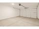Spacious garage with clean concrete floors and an automatic door at 3451 E Alexander Dr, San Tan Valley, AZ 85143