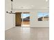 Bright, open-concept living room with tile floors, a chandelier, and access to the patio at 3451 E Alexander Dr, San Tan Valley, AZ 85143