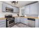 Updated kitchen with stainless steel appliances and wood countertops at 821 E Roeser Rd, Phoenix, AZ 85040
