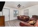 Living room with brown leather couches and wood flooring at 821 E Roeser Rd, Phoenix, AZ 85040