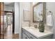 Bright bathroom featuring modern mirror, cabinetry and stylish sink with a hallway view at 34599 N 99Th Way, Scottsdale, AZ 85262