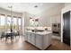 Gourmet kitchen features white cabinets, stainless steel appliances, large island, and adjacent breakfast nook at 34599 N 99Th Way, Scottsdale, AZ 85262