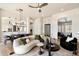 Bright living room with modern decor including curved sofa, fireplace, and views to the kitchen and dining area at 34599 N 99Th Way, Scottsdale, AZ 85262