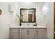Stylish powder room with modern vanity, decorative mirror, and warm lighting at 34599 N 99Th Way, Scottsdale, AZ 85262