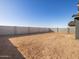 Large, unlandscaped backyard with block wall at 36933 W La Paz St, Maricopa, AZ 85138