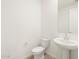 Simple bathroom with pedestal sink and toilet at 36933 W La Paz St, Maricopa, AZ 85138