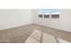 Bright bedroom with neutral carpet and large window at 36933 W La Paz St, Maricopa, AZ 85138