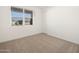 Simple bedroom with carpeted floor and a window with blinds at 36933 W La Paz St, Maricopa, AZ 85138