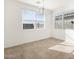 Dining room with tile floors and modern chandelier at 36933 W La Paz St, Maricopa, AZ 85138