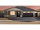 Gray house with brown garage door, stone accents, and landscaping at 36933 W La Paz St, Maricopa, AZ 85138