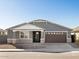 Two-story house with gray exterior, brown garage door, and stone accents at 36933 W La Paz St, Maricopa, AZ 85138