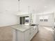 Open concept kitchen with island and granite countertops at 36933 W La Paz St, Maricopa, AZ 85138