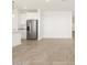 Contemporary kitchen featuring white cabinetry, granite countertops and stainless steel appliances at 36933 W La Paz St, Maricopa, AZ 85138
