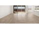 Living room with tile floors, sliding doors to patio, and kitchen views at 36933 W La Paz St, Maricopa, AZ 85138