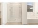 Walk-in shower with glass enclosure and built-in shelving at 36933 W La Paz St, Maricopa, AZ 85138