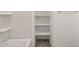 Bathroom featuring built-in shelving and neutral tile flooring at 36944 W Prado St, Maricopa, AZ 85138
