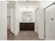 Bathroom featuring double sink vanity, tiled floor, and glass-enclosed shower at 36944 W Prado St, Maricopa, AZ 85138