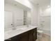 Modern bathroom with double sinks, sleek vanity, and shower-tub combo at 36944 W Prado St, Maricopa, AZ 85138