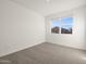 Bright bedroom with neutral carpet and large window, perfect for relaxation at 36944 W Prado St, Maricopa, AZ 85138