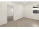 A bright bedroom featuring neutral tile floors and natural light at 36944 W Prado St, Maricopa, AZ 85138