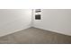 This cozy bedroom includes plush carpeting and a window for natural light at 36944 W Prado St, Maricopa, AZ 85138