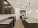 Spacious kitchen featuring stainless steel appliances, granite countertops, and dark cabinetry at 36944 W Prado St, Maricopa, AZ 85138