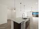 Kitchen featuring stainless steel appliances, granite countertops, and dark cabinetry at 36944 W Prado St, Maricopa, AZ 85138