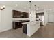 Kitchen featuring granite countertops, dark wood cabinets and stainless steel appliances at 36944 W Prado St, Maricopa, AZ 85138
