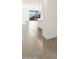 Open concept living room featuring tile flooring and a large window at 36944 W Prado St, Maricopa, AZ 85138