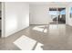 Living room with tile flooring and sliding glass door to backyard at 36944 W Prado St, Maricopa, AZ 85138