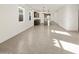 Open-concept living room and kitchen with ceramic tile flooring at 36944 W Prado St, Maricopa, AZ 85138
