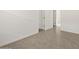 A room featuring tile floors, white walls and several doorways at 36944 W Prado St, Maricopa, AZ 85138
