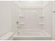 Clean bathroom with shower/tub combo and built-in shelves at 36973 W La Paz St, Maricopa, AZ 85138
