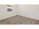 Bright bedroom featuring neutral carpeting and a window at 36973 W La Paz St, Maricopa, AZ 85138