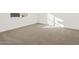Well-lit bedroom with neutral carpeting and window at 36973 W La Paz St, Maricopa, AZ 85138