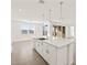 Modern kitchen with island, stainless steel appliances, and white cabinets at 36973 W La Paz St, Maricopa, AZ 85138