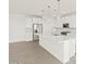 Island kitchen with white cabinets and stainless steel appliances at 36973 W La Paz St, Maricopa, AZ 85138