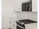 Modern kitchen with white cabinets and stainless steel appliances at 36973 W La Paz St, Maricopa, AZ 85138