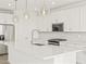 Modern kitchen with white cabinets, quartz countertops, and island at 36973 W La Paz St, Maricopa, AZ 85138