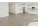 Open concept living room with view of kitchen and stainless steel appliances at 36973 W La Paz St, Maricopa, AZ 85138