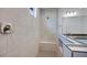 Contemporary shower with seat, gray tile, and glass partition with modern fixture at 17134 W Hackamore Dr, Surprise, AZ 85387