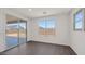 Bright bedroom with hardwood flooring, large windows, and sliding glass doors leading to the backyard at 17134 W Hackamore Dr, Surprise, AZ 85387
