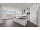 Bright kitchen with white cabinets, stainless steel appliances, and sleek black countertops at 17134 W Hackamore Dr, Surprise, AZ 85387