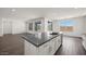 Bright eat-in kitchen featuring sleek countertops, an island, and ample natural light at 17134 W Hackamore Dr, Surprise, AZ 85387