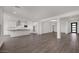 Spacious open concept living space connects the kitchen and living room, showcasing hardwood floors and modern design at 17134 W Hackamore Dr, Surprise, AZ 85387