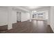 Open-concept living room featuring modern lighting, hardwood flooring, and large windows for plenty of natural light at 17134 W Hackamore Dr, Surprise, AZ 85387