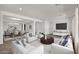 Open-concept living room featuring white sofas, dining area, and dark wood floors at 17134 W Hackamore Dr, Surprise, AZ 85387