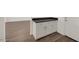 A mudroom with white cabinets, a black countertop, and wood-look tile flooring that provides a clean and organized transition space at 17134 W Hackamore Dr, Surprise, AZ 85387