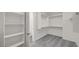This walk-in closet features built-in shelving and ample hanging space providing practical storage solutions at 17134 W Hackamore Dr, Surprise, AZ 85387